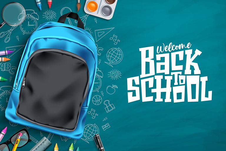 Backpack with school supplies around it on a chalkboard
