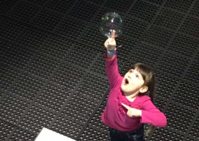 PCI Homeschool Guild student touching a bubble