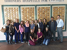 Career Tech Ed students standing in-front of plaques at Shriners Hospital