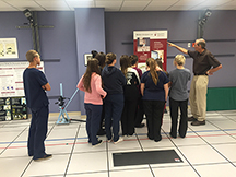 Career Tech Ed students looking at poster inside Shriners Hospital